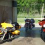 Cleaning the bikes after riding down a muddy road to the airboat ride.