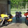 Cleaning the bikes after riding down a muddy road to the airboat ride.